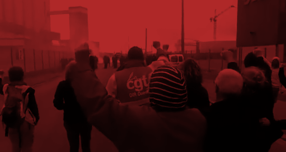 Blockade of refinery in Marseille June 2016 Workers inside a refinery near Marseille/France, with rosen fists, some of them have grey hair. In the background police coming towards them and teargas