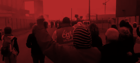 Workers inside a refinery near Marseille/France, with rosen fists, some of them have grey hair. In the background police coming towards them and teargas 