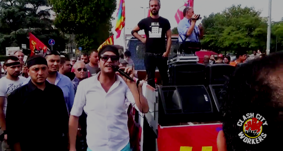 Demonstration, among the people a man with a microphone beside the vehicle with the loudspeakers