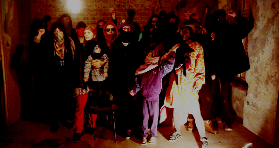 15 disguised squatters with children in revolutionary pose