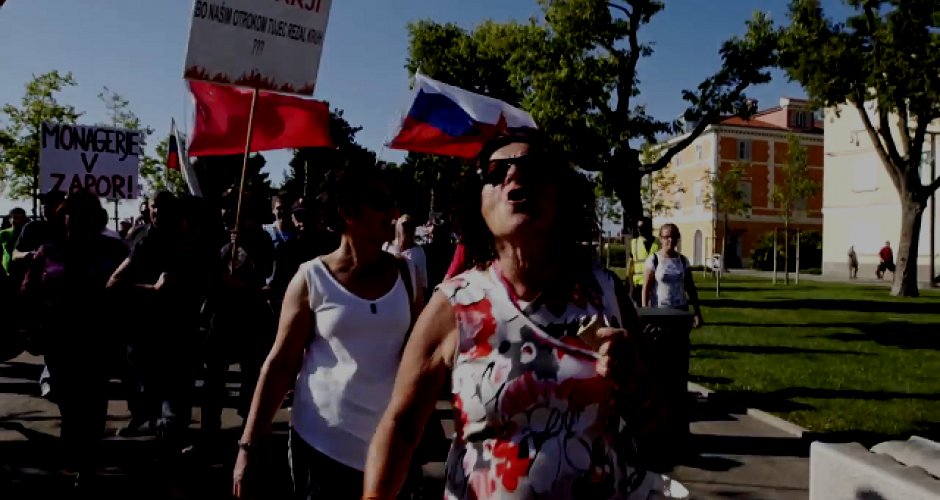 Demonstration in Koper women demonstrate. In the background a red flag and slowenian flag