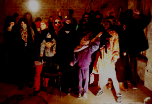 15 disguised squatters with children in revolutionary pose