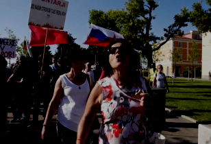 Demonstration in Koper women demonstrate. In the background a red flag and slowenian flag